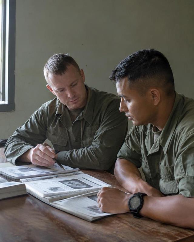 Army Fighting Secrets editorial team Instructors reviewing printed training manuals